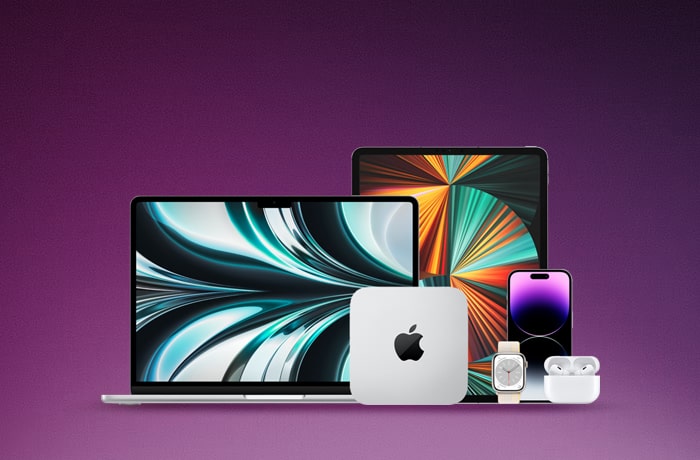 Une collection de produits Apple affichés sur un fond violet, notamment un MacBook, un iPad, un iPhone, un Mac Mini et des Airpods, tous présentant des fonds d'écran aux couleurs vives.